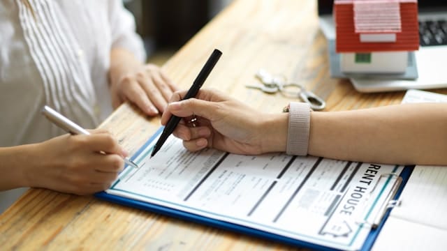 Signing a rental agreement.